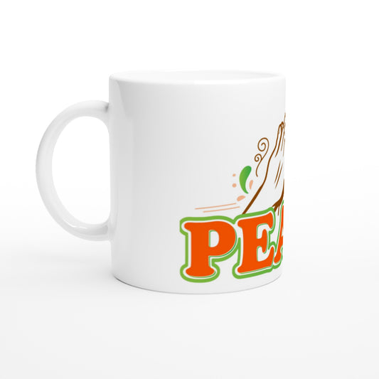 White ceramic cup with the hand claps in prayer and the word peace written in burnt orange and green